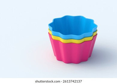 Stack of silicone molds for muffin or cupcake on light gray background. Bakeware tool. Cooking accessories. Copy space. 3d render