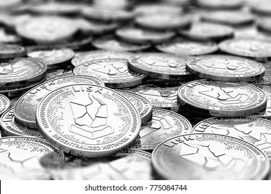 Stack of silver LISK coins in blurry closeup with copy space above in blurred area. 3D rendering