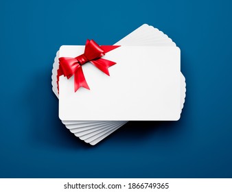 Stack Of White Credit Or Gift Cards With Red Ribbon Isolated On Bluebackground - 3D Illustration