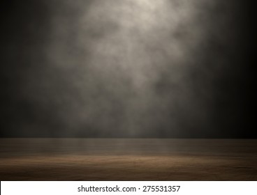 An stage lit by a single spotlight on a dark background - Shutterstock ID 275531357