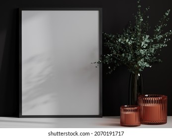 Still Life With Orange Brown Glass Candles And A Large Painting In A Black Frame. Solid Black Wall.There Are Branches Of Plants In A Vase. Mockup For Vertical Art Or Pictures. 3d Rendering