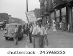 Striking workers picketing a reality company. Sign reads 