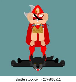 Strong Adult Red Riding Hood and wolf skin trophy hunting. Strong female warrior in red cloak. Powerful woman protector. Beautiful lady