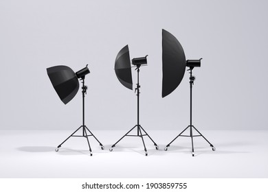 Studio Lighting Stands With Flash, Umbrella And Softbox On White Background. 3d Render And Illustration Of Professional Photography Equipment.