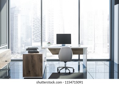Stylish manager office with wooden computer table standing on a tiled floor in a gray panel room. Loft window. 3d rendering mock up