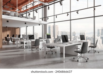 Stylish office interior with pc computers and shared desk in row, side view concrete floor. Two-storey stylish coworking space with panoramic window on Kuala Lumpur skyscrapers. 3D rendering