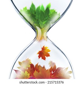 From Summer To Autumn.The Changing Seasons Concept With Hourglass