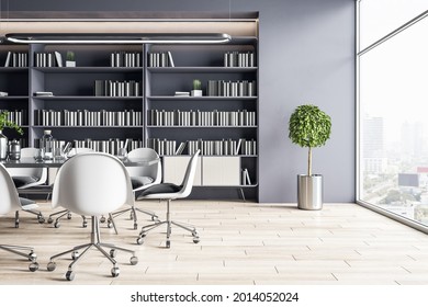 Sunny Spacious Office Hall With White Chairs Around Conference Table On Big Library Bookcase Background And City View From Huge Window. 3D Rendering