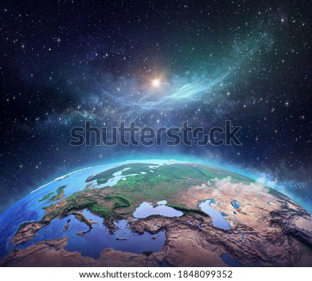 Surface of Planet Earth, space view of the World focused on Europe, galaxies, star cluster, nebula and the Sun shining far behind. 3D illustration - Elements of this image furnished by NASA
