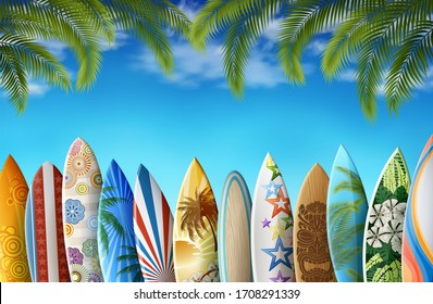 Surfboards in row, with original design, with colorful print, on the background of clear sky, and palm leafs.