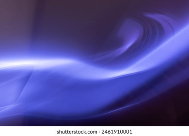 A surreal, abstract image featuring a sinuous wave of blue light blending seamlessly into the darker background. The image has a sense of motion and mystery, with smooth curves