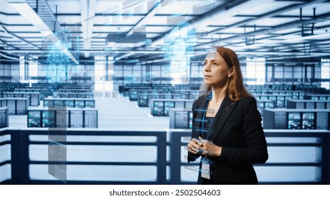 System administrator using augmented reality technology in data center, comparing parameters. Server farm manager looks at AR simulation, overseeing performance benchmarks - Powered by Shutterstock