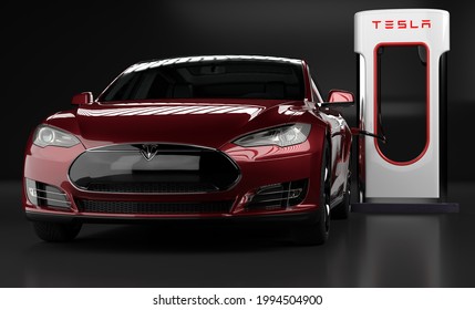 Szczecin, Poland-June 2021:Tesla Model S Electric Limousine and Tesla Supercharger on a black background.3D illustration.