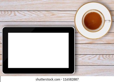 tablet computer and coffee cup