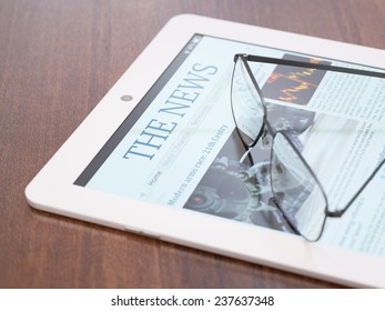 Tablet PC with newspaper application and glasses