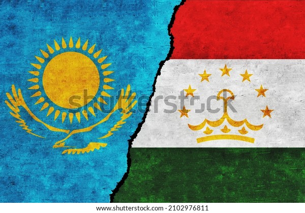 Tajikistan and Kazakhstan painted flags on a\
wall with a crack. Tajikistan and Kazakhstan relations. Kazakhstan\
and Tajikistan flags\
together
