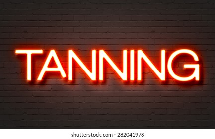 Tanning Neon Sign On Brick Wall Background