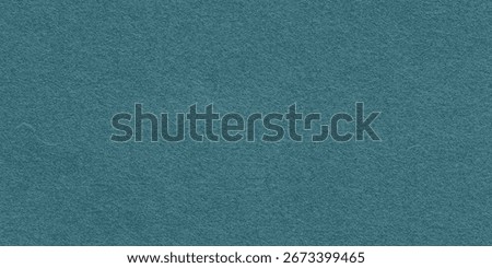 Teal felt background with a soft texture. The background is teal, offering a cozy and smooth appearance, perfect for crafting designs. Green background with copy space.
