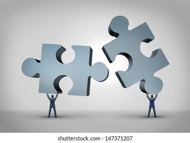 Teamwork And Leadership Business Concept As Two Giant Three Dimensional Puzzle Pieces Coming Together From A Partnership Agreement Between Two Powerful Leaders Who Are Building A Successful Company.