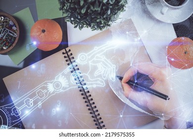 Tech theme hologram over woman's hands taking notes background. Concept of hightech. Double exposure