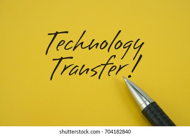 Technology Transfer! Note With Pen On Yellow Background