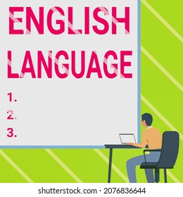 Text Sign Showing English Language. Word Written On Third Spoken Native Lang In World After Chinese And Spanish Man Sitting Armchair Using Laptop Placed On Table With Large Blank Board.