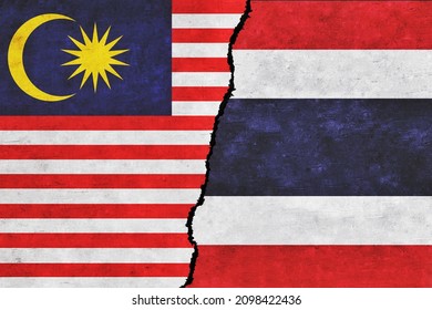 Thailand and Malaysia painted flags on a wall with a crack. Thailand and Malaysia relations. Malaysia and Thailand flags together. Thailand vs Malaysia