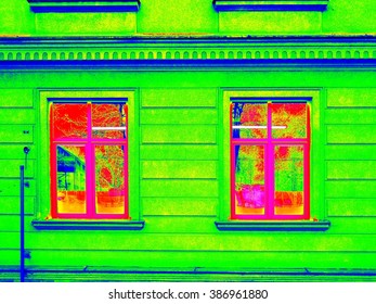 Thermography measurement scan. Traditional construction of bricks house with old style windows. Thermal waste map. 