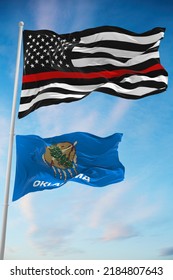 Thin Red Line Black Flag Of US With Smaller Flag Of Oklahoma State, Usa At Cloudy Sky Background. United States Of America Firefighter Flag. Copy Space For Vertical Banner. 3d Illustration