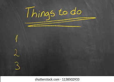 Things to do list chalk text on blackboard or chalkboard as management priorities schedule task concept with empty copy space