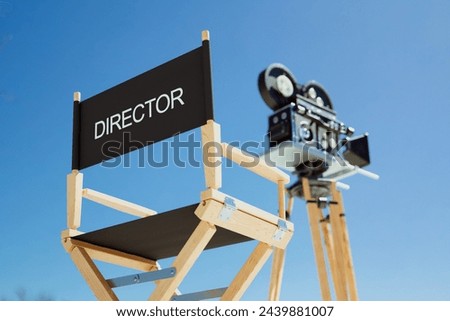 This compelling scene captures a vintage director's chair, inscribed with 'DIRECTOR', alongside a classic film camera, all set against the backdrop of a vivid blue sky.