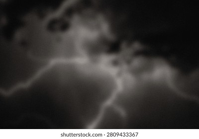 This image captures a faint, shadowy silhouette of a bird in mid-flight, set against a dark and turbulent sky. The bird's form is barely distinguishable due to the low light and heavy cloud cover, giving it an ethereal and mysterious appearance. The overall mood of the image is dramatic, emphasizing the bird’s solitary journey through a stormy atmosphere with a sense of motion and freedom.