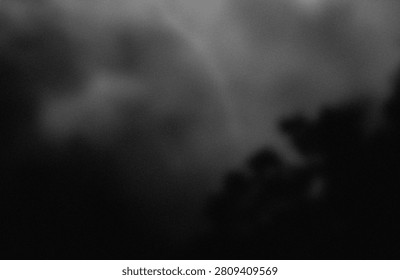 This image captures a moody and dramatic sky filled with dense, swirling clouds that obscure the view. The overall atmosphere is dark and foreboding, suggesting an impending storm or a heavily overcast evening. The clouds appear thick and voluminous, creating a sense of depth and movement.