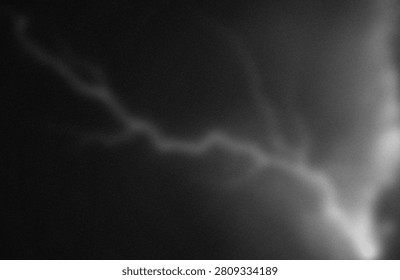 This image captures a striking and ethereal view of a cosmic nebula, characterized by its intricate, wispy structures and varying densities of interstellar dust and gas. The nebula exhibits a gradient of luminosity, with darker regions indicating denser clouds and lighter areas revealing the glow of ionized gases. The composition suggests a dynamic environment, possibly a region of star formation or remnants of a supernova, illuminated by distant cosmic light sources.