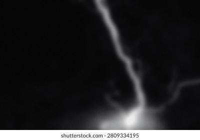 This image captures a striking view of a luminous nebula stream, extending gracefully through the vast expanse of deep space. The bright, wispy tendrils of gas and dust create a captivating contrast against the dark cosmic backdrop. The brightest section at the bottom suggests a dense region, potentially indicating areas of star formation or intense stellar activity. The interplay of light and shadow highlights the intricate structures within the nebula, showcasing the beauty and complexity of interstellar phenomena.