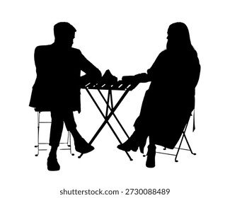 This image depicts the silhouettes of two individuals engaged in a formal handshake. They are seated on folding chairs, facing each other across a small table. The scene suggests a professional or business meeting, emphasizing the act of agreement or partnership.
