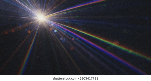 This image depicts a starburst effect created by a bright light source, featuring spectral rays and chromatic aberration against a dark background.
