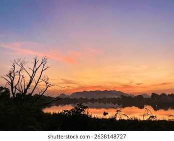 This image evokes a sense of calm and serenity. The soft, warm hues of the sunset blending into the cool tones of the twilight sky create a peaceful and almost dreamlike atmosphere.