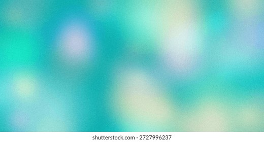 This image features an abstract, blurred colorscape with soft, overlapping hues of blue, green, and white. The gentle blending of colors creates a soothing and calming effect, evoking a sense of tranquility and serenity. The lack of distinct shapes or objects allows the viewer to focus on the interplay of colors and the smooth transitions between them.