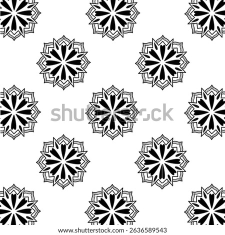 This image features a black and white geometric pattern resembling a floral or snowflake-like design. The symmetrical motif consists of sharp-edged elements radiating from the center, filled with blac