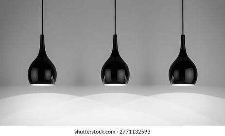 This image features three modern black pendant lights suspended from the ceiling against a plain gray background. The sleek and minimalist design of the lamps creates a sophisticated ambiance, making it suitable for various interior design settings. The clean and empty space emphasizes the lighting fixtures, highlighting their elegant and contemporary style.