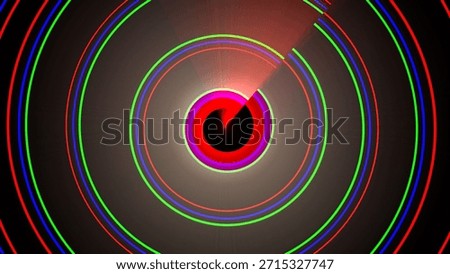 This image features a vibrant, abstract spiral pattern composed of multiple concentric circles in red, green, and blue. The circles create a mesmerizing visual effect, with a bright light source at the center emitting rays outward. The background is dark, which accentuates the vivid colors and intricate design.