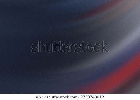 This image showcases a close-up view of an abstract texture featuring a smooth gradient blend of dark shades, primarily grays, with faint hints of red and blue near the bottom right corner. The texture appears slightly grainy, giving it a tactile, almost tactile-feel quality that could be reminiscent of a fabric or painted surface.