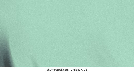 This image showcases a soft mint green background with a subtle texture that gives it a gentle, calming appearance. The presence of slight folds adds a sense of depth and tactility to the image. The o