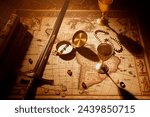 This still life captures a vintage map adorned with time-honored exploration tools: a compass, sword, goblets, and ancient coins, all bathed in dramatic lighting.