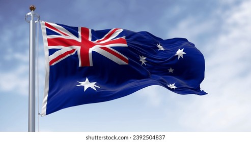 Three Australia national flags waving in the wind on a clear day. Blue flag with Union Jack, white 5-pointed star symbolizing Southern Cross. 3D illustration render. Rippling fabric - Powered by Shutterstock