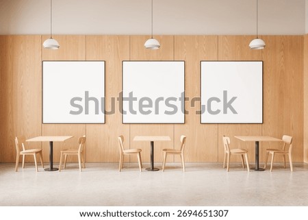 Three blank poster mockups on wooden wall in modern cafe interior with wooden furniture and pendant lights, showcasing branding or product concept. 3D Rendering
