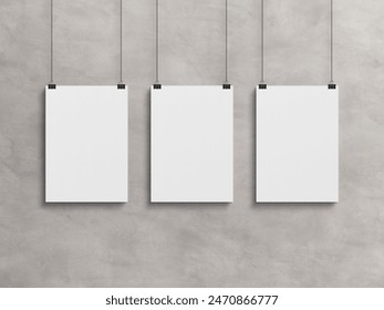 Three Blank vertical poster hanging with clips on a concrete wall Mockup. 3D rendrering