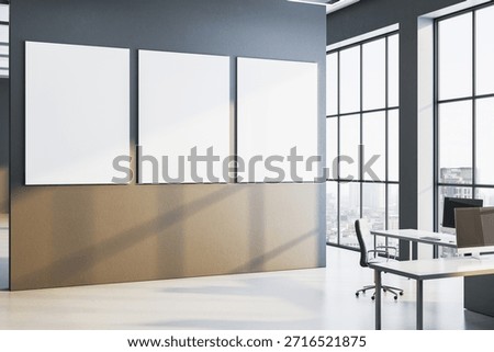 Three blank vertical posters on a modern wall in a corporate office interior with large windows, city view, sunlight and shadows. 3D Rendering