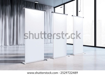 Three empty display stands positioned in a bright gallery with large windows, perfect for showcasing artwork or information. 3D Rendering